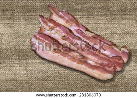 Three Belly bacon rashers on Natural Linen canvas Background