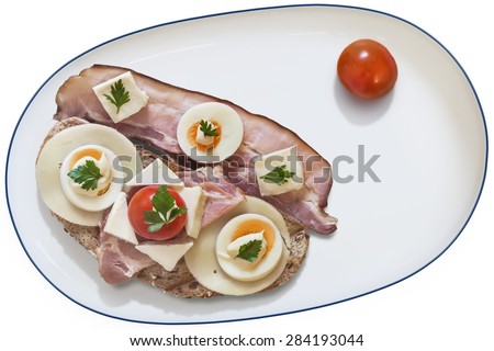 Toast Sandwich in white Porcelain Platter, with Ham, Cheese, hard boiled Egg slices, Mayonnaise and Parsley leaves, some extra Pork Rasher, and Cherry Tomato, isolated on White Background.