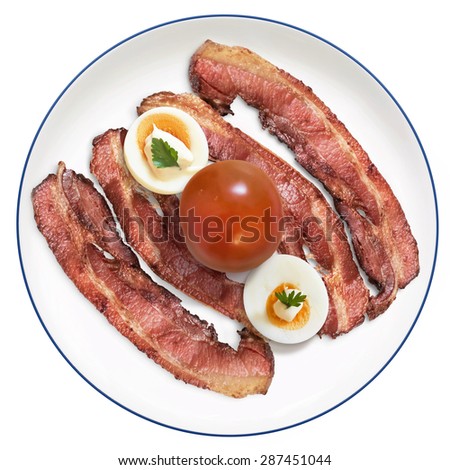 Fried Bacon Rashers with two hard boiled Egg slices with Mayonnaise and Parsley leaves, with Tomato on Porcelain Plate, Isolated on White Background.
