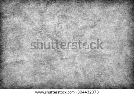 Photograph of old Gray animal skin parchment, creased, coarse, vignette grunge texture sample.