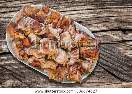Plateful of Spit Roasted Pork Cut in Slices, on Old Wooden Background.