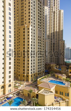 DUBAI - MARCH 24, 2013: Residential skyscraper with swimming pool at Dubai Marina taken on March 24, 2013 in Dubai, United Arab Emirates.