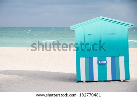MIAMI BEACH - JANUARY 25, 2014: Blue and turquoise beach hut with ocean and sand taken on January 25, 2014 in Miami Beach, USA