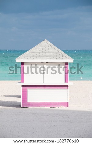 MIAMI BEACH - JANUARY 25, 2014: Pink beach hut with ocean and sand taken on January 25, 2014 in Miami Beach, USA