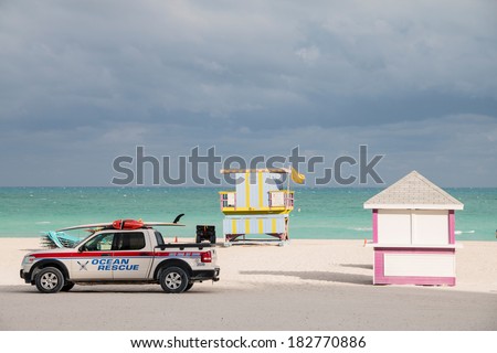 MIAMI BEACH - JANUARY 25, 2014: Pink beach hut with ocean and sand and ocean rescue truck taken on January 25, 2014 in Miami Beach, USA