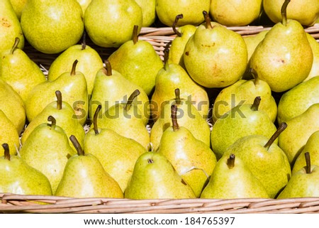 A selection of green and yellow pears in a basket taken on an organic French farmer\'s market
