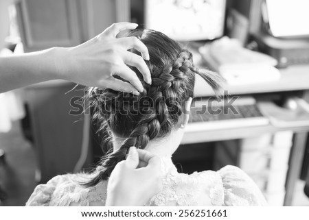 A bride at hairdressing salon before wedding in black and white photo