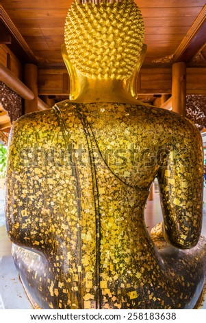 The gold leaf on the back of Buddha statue in temple of Thailand. For the background and textures.