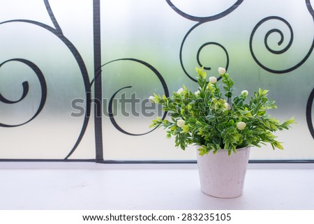 Small artificial tree in a pot. Concept image for interior design and decoration of home and office.