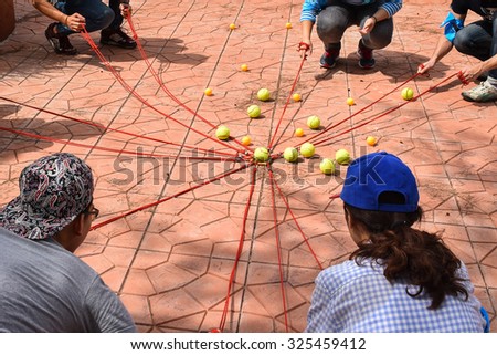 Team building activity, Tennis balls and table tennis balls with rope in harmonize activity