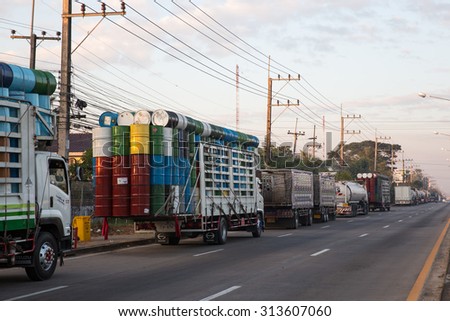 MAE SOT THAILAND - DECEMBER14 : Trucks bringing goods for export so that the fluid tanks 200 liters on Asia road not far from the border Thailand - Myanmar at Mae Sot, Thailand on DECEMBER14,2014