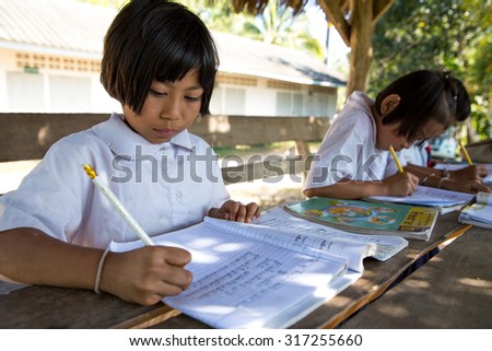 MAE SOT THAILAND - NOV26 : Ethnic Karen students  are copying Thai handwriting practice at the school Ban Khun Huai Mae Sot, Tambol Phra That Pha Daeng, Mae Sot, Tak, Thailand on NOVEMBER26, 2014
