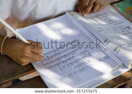 MAE SOT THAILAND - NOV26 : Ethnic Karen student  is copying Thai handwriting practice at the school Ban Khun Huai Mae Sot, Tambol Phra That Pha Daeng, Mae Sot, Tak, Thailand on NOVEMBER26, 2014