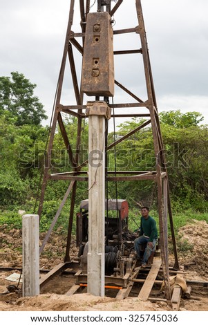 MAE SOT, THAILAND - OCT9 : Unidentified worker is placing cement stack in soil under construction of Road at Mae Sot, Tak, Thailand on OCTOBER9, 2015.