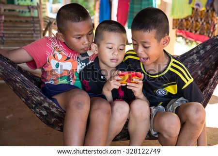 MAE SOT, THAILAND - OCT16 : Unidentified  children of migrant Myanmar workers are playing mobile smartphone at Ban Mae Tao, Mae Sot, Thailand on OCTOBER16, 2015
