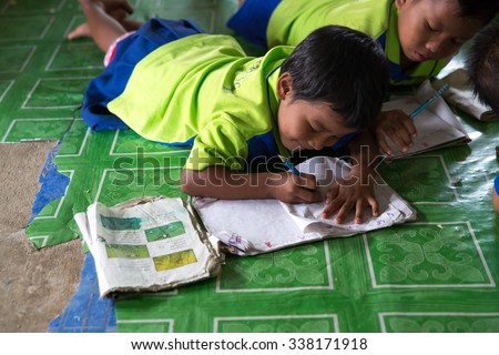 MAE SOT, THAILAND - NOVEMBER11, 2015 : Unidentified children of migrant workers studying  at non-formal learning place near plant the parents their work at MAE SOT, THAILAND.