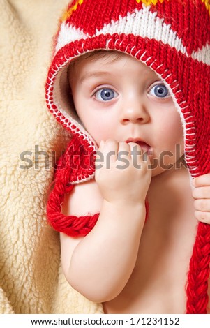 Blue eyed baby in red bonnet