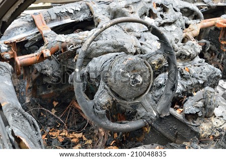 Steering wheel and dashboard of a burnt-out car.