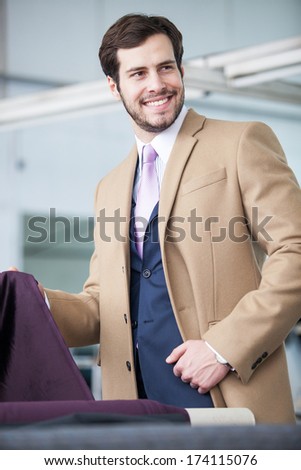 handsome business man with a textile in his hand looking on right side