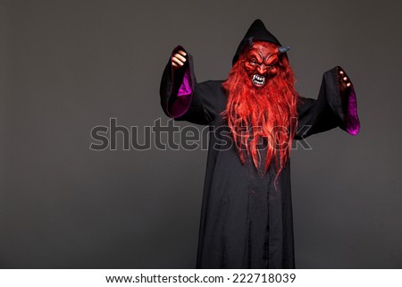 halloween monster with red face on dark background
