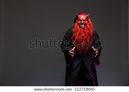 halloween monster with red face on dark background