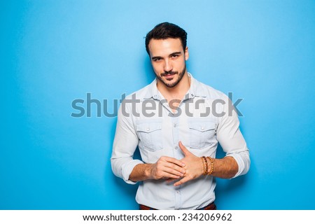 sexy and confident handsome man on a blue background