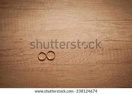 wedding rings on the wooden board