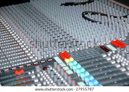Audio mixing console in a recording studio. Faders and knobs of a sound mixer.