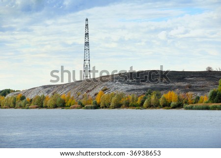 High voltage line and electricity pylon on cretaceous mountains on a coastline of the river Don. Russia.
