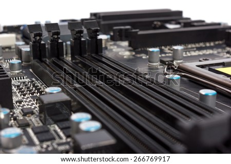 Electronics components on modern PC computer motherboard with RAM connector slot