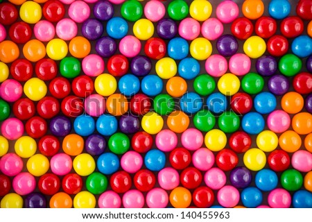 Brightly colored gum balls laying flat, background