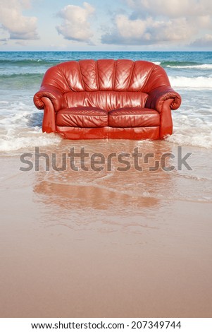 red vintage sofa in the sea