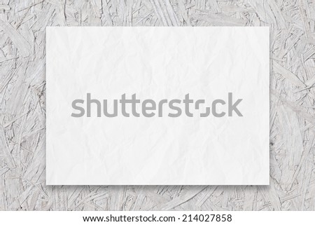 white OSB wall and crumpled blank list of paper