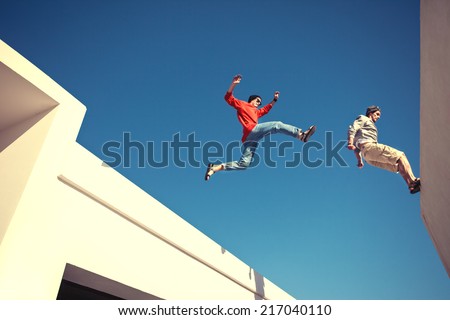 two brave men jumping over the roof, and little motion blur