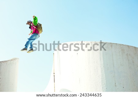 brave man jumping over the concrete wall