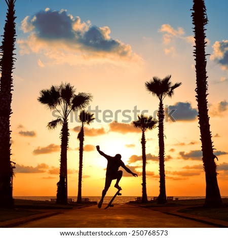 man jumping on skateboard near the ocean in sunset
