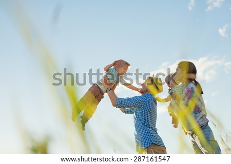happy family playing outdoors in the park with children