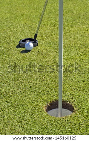 Golf ball and stick in the final hit to the hole