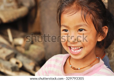 Nagaland, India - March 2012: Portrait of happy girl smiling, Nagaland, remote region of India. Documentary editorial.
