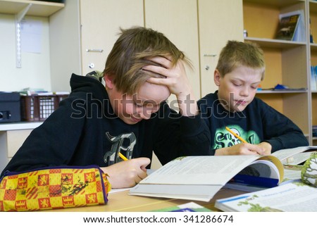 Rovaniemi, Finland - May, 2007: Two young boys do their exercises from English language at primary school in Finland. Documentary editorial.