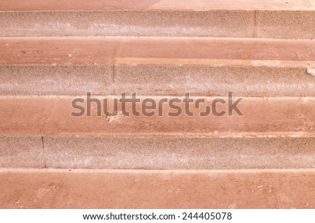 The steps which are laid out by a red granite tile