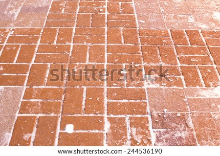 The brick pavement which is laid out by a red stone