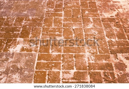 The brick pavement which is laid out by a red stone