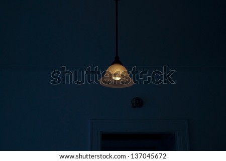 A light peaking through a dark living room