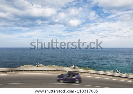 Coast road with motion blurred car
