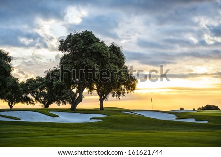 Sunset And Golf Course With Flag