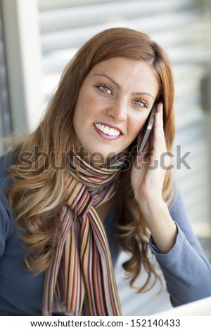 attractive lady on phone and looking at camera