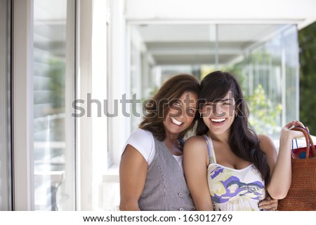 two ladies with big smiles and looking at camera