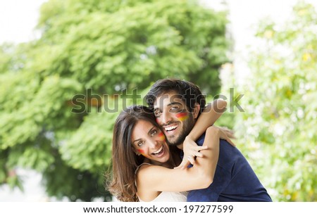 man and woman with flags of different countries painted