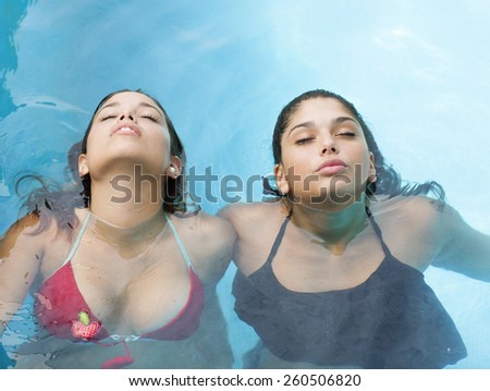 Two young women with their heads above water